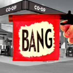 A toy gun in from of a backdrop of a co-op gas station