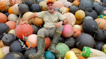 Artist Pete Clarkson sitting amidst the medium he uses for his sculptures. Credit: Clarkson