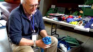 Ruedi Pletscher's passion for knot-tying is evident in his joyful expression, as he expertly weaves together the intricate strands of his latest creation.