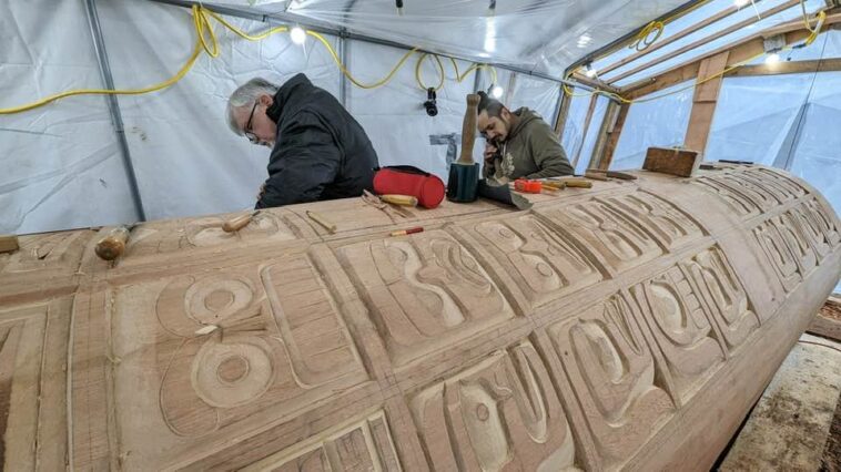 Stan Hunt and his nephew Curtis Dickie working on the Indian Residential School Memorial Monument. This significant project involved the hand-carving of 130 individual faces, representing the children who suffered or never came home from the Indian Residential Schools.