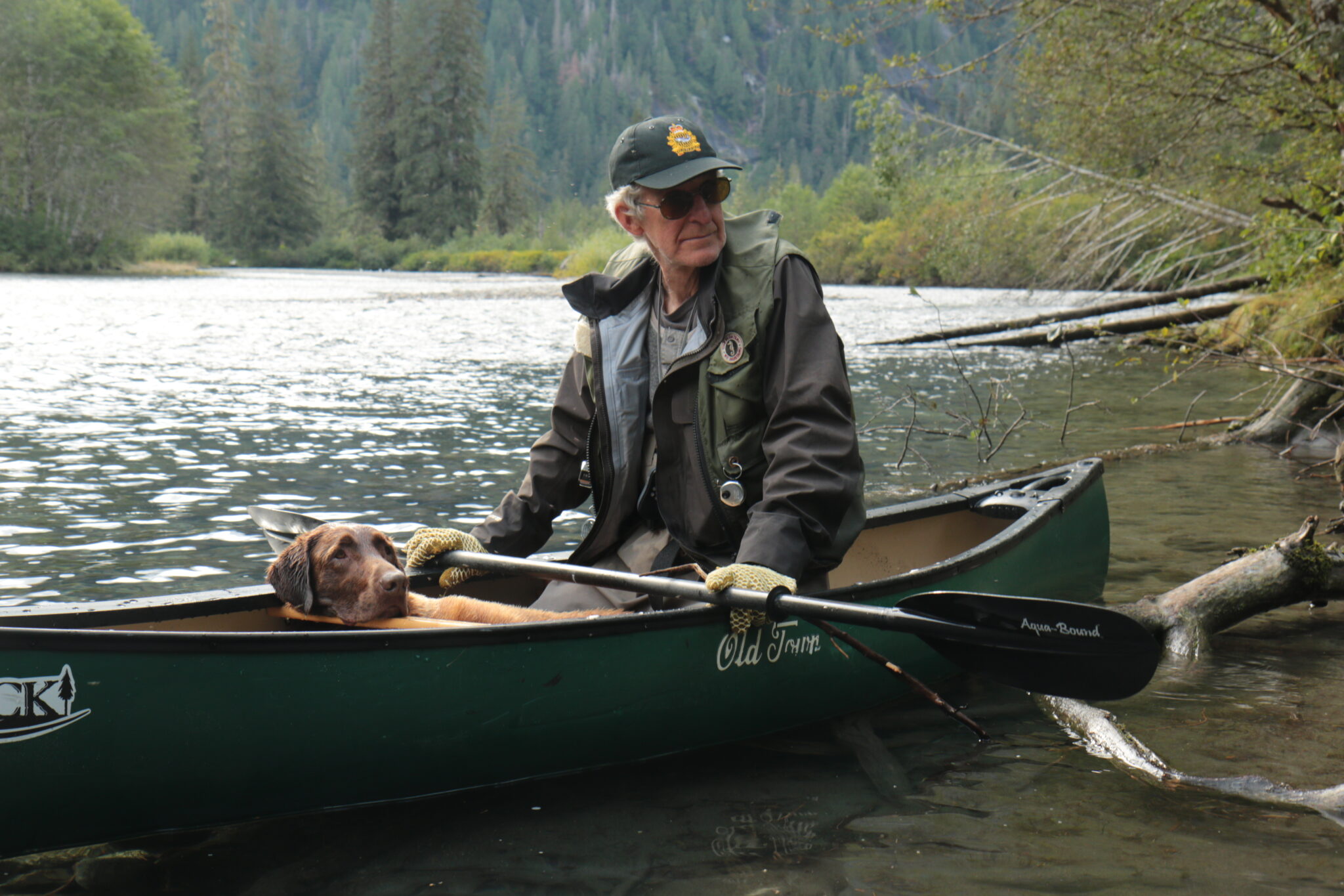 A man with a dog on a canoe