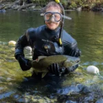 Zach Kapelan holds a chinook salmon.