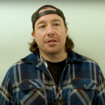 A picture of Jarred Sparrow in a plaid shirt and a cap.