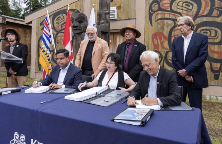 Member of the Kitselas First Nations joined by representatives of the BC government to initial a new treaty.